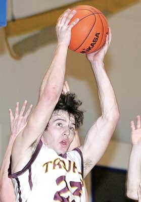 Paul Sievers/The Western News Aaron Palmer goes high for an offensive rebound during Saturday's game against Eureka. Palmer accounted for 62.9 percent of the Trojans' offense in the 47-35 loss.