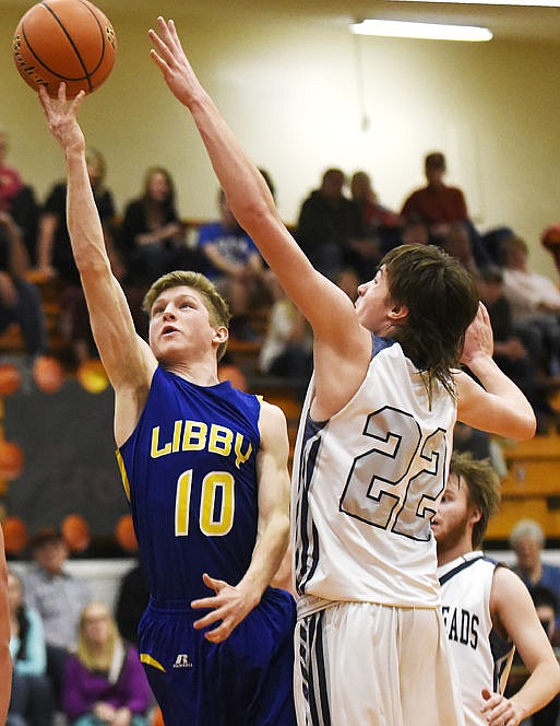 &lt;p&gt;Libby's Jonny Cielak soars past Anaconda's Trent Mikalatos for a basket in the Loggers' 69-64 victory in the opening round of the Western B Divisionals at Flathead on Thursday. (Aaric Bryan/Daily Inter Lake)&lt;/p&gt;