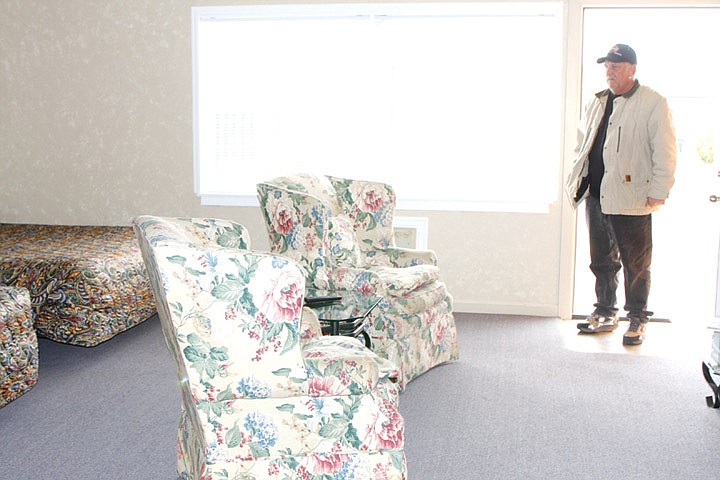 Sage N Sand Motel owner Richard Nichols stands in the doorway of a remodeled room at the Moses Lake business.