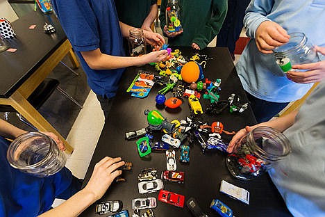 &lt;p&gt;Students at Holy Family Catholic School sort through toys while filling mason jars to benefit children of the Union Gospel Mission.&lt;/p&gt;