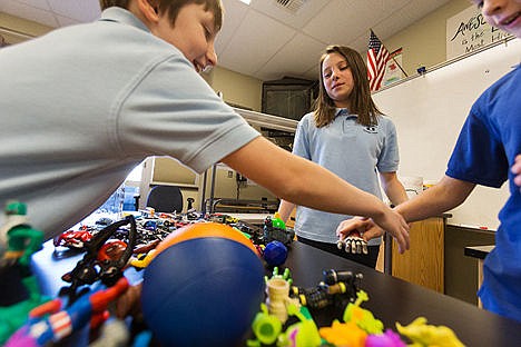 &lt;p&gt;Katy watches as classmates choose toys to put into jars.&lt;/p&gt;