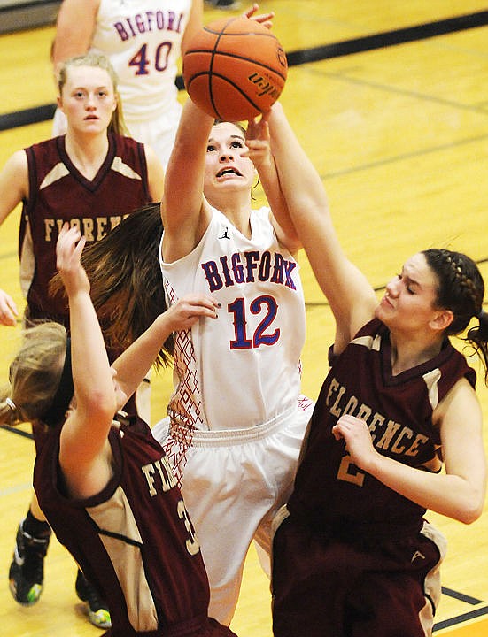 &lt;p&gt;Bigfork&#146;s Marissa Hiza fights her way through a crowd of Florence defenders to put up a shot during opening-round action Wednesday at the Western B divisional girls basketball tournament at Flathead High School. (Aaric Bryan/Daily Inter Lake)&lt;/p&gt;