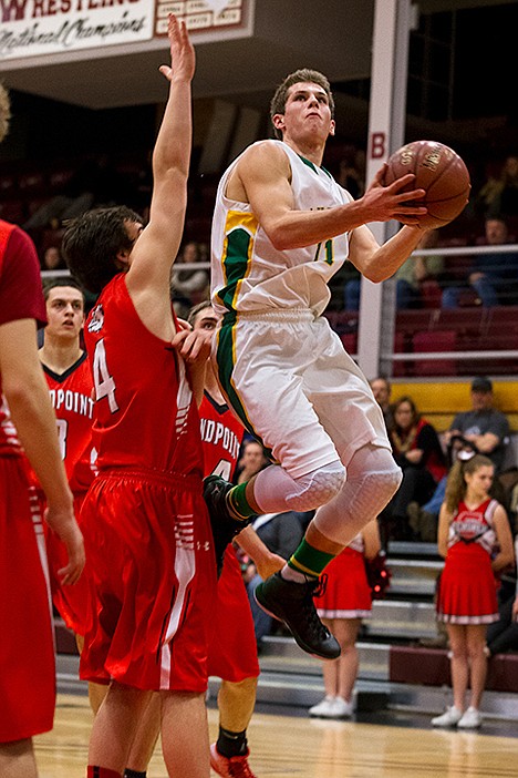 <p>Lakeland guard Tyrel Derrick goes up against Sandpoints Cooper Spalding to score in the second quarter.</p>