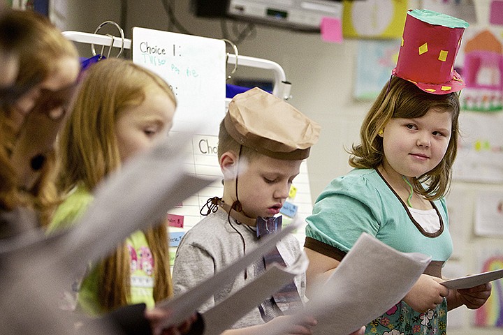 &lt;p&gt;JEROME A. POLLOS/Press Rayenne Stone watches her cast mates in the play &quot;How Beatle Got Her Jeweled Coat&quot; during a student-led performance Wednesday in Debi O'Donnell's second-grade class at West Ridge Elementary in Post Falls. The reader&#146;s theatre performance gives students the opportunity to use new words they have learned in speaking situations as well as designing and creating their own costumes. Students are also given the opportunity to practice speaking, listening, to be heard and understood.&lt;/p&gt;