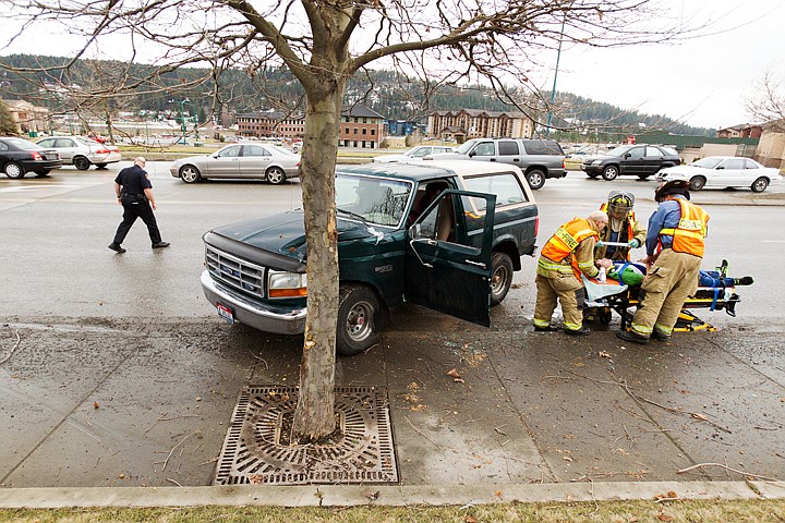 &lt;p&gt;SHAWN GUST/Press Emergency personnel with the Coeur d'Alene Fire Department treat a man who was driving an SUV when it collided with a tree near Northwest Boulevard Tuesday in Coeur d'Alene. According to witnesses, the man who had complained of back and chest pain and was transported to Kootenai Medical Center.&lt;/p&gt;