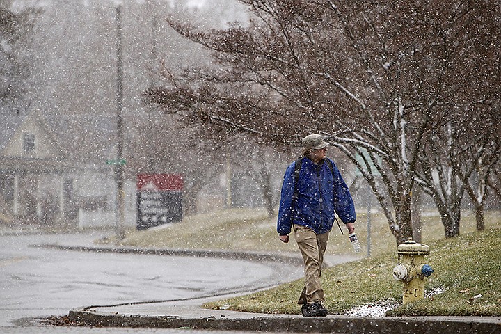 &lt;p&gt;JEROME A. POLLOS/Press Josh Gradin walks along Garden Avenue during Thursday's snow fall near North Idaho College in Coeur d'Alene.&lt;/p&gt;