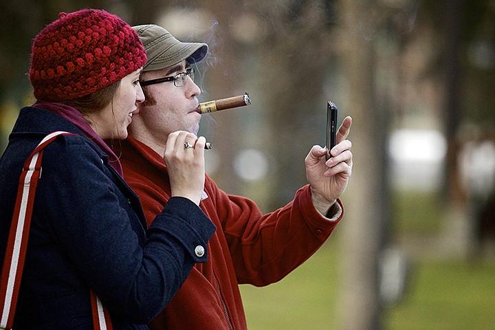 &lt;p&gt;JEROME A. POLLOS/Press Justin Graham poses for a cell-phone picture with his friend Annie McNeil, visiting from Golden, Colo., as they enjoy cigars while on a stroll along the beach area Monday at Independence Point.&lt;/p&gt;