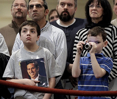 &lt;p&gt;Jacob Mattia, left, holds a photo of Republican presidential candidate, former Pennsylvania Sen. Rick Santorum as Dale Price, right, takes photos as Santourm speaks at a Tea Party rally Saturday in St. Clair Shores, Mich.&lt;/p&gt;