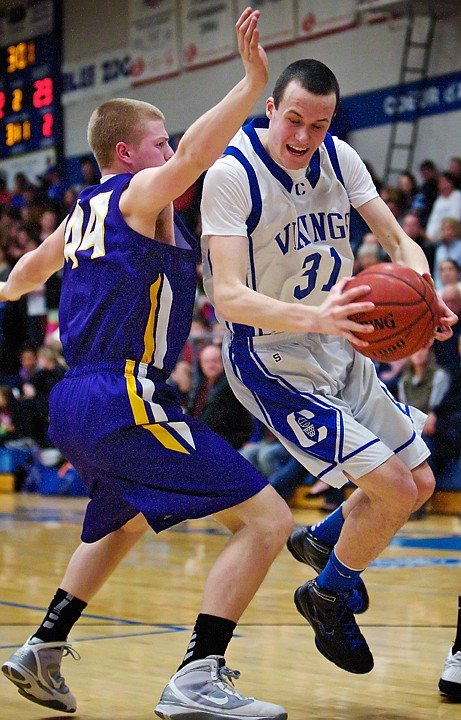 <p>Coeur d'Alene High's Ty Higbie tries to jump through the defensive coverage of Riley Beck from Lewiston High during the first half.</p>
