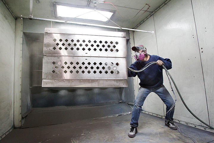 &lt;p&gt;James Hinrich, a lead powder coater at Heater Craft, sprays a coat of paint on a collapsable dog kennel during a recent shift.&lt;/p&gt;