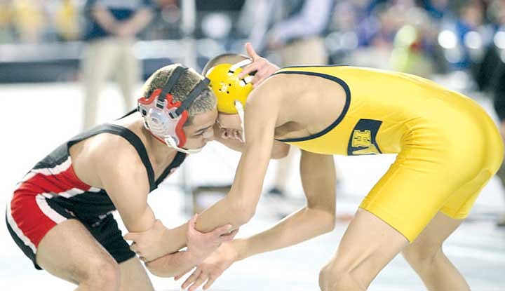 Isaiah Barrera (black) grapples with Carlos Lopez (yellow) in the 2A 106-pound final. Barrera prevailed, 5-4.