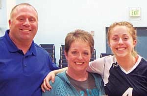 Ronda McPhetridge (center) with husband Randy and daughter Ame on Senior Night at Moses Lake Christian Academy. Ronda, the elementary school secretary at the academy, was preparing to start a running program but recently suffered a stroke. Elementary school students are 'Running for Ronda' to show their support for their school's secretary as she recovers.