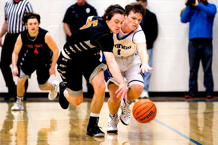 &lt;p&gt;Post Falls' Max McCullough and Coeur d'Alene's Austin Lee battle for posession of a loose ball at the 5A Region 1 second-place game on Thursday, Feb. 25, 2016 at Coeur d'Alene High School. Post Falls defeated Coeur d'Alene 77-70.&lt;/p&gt;