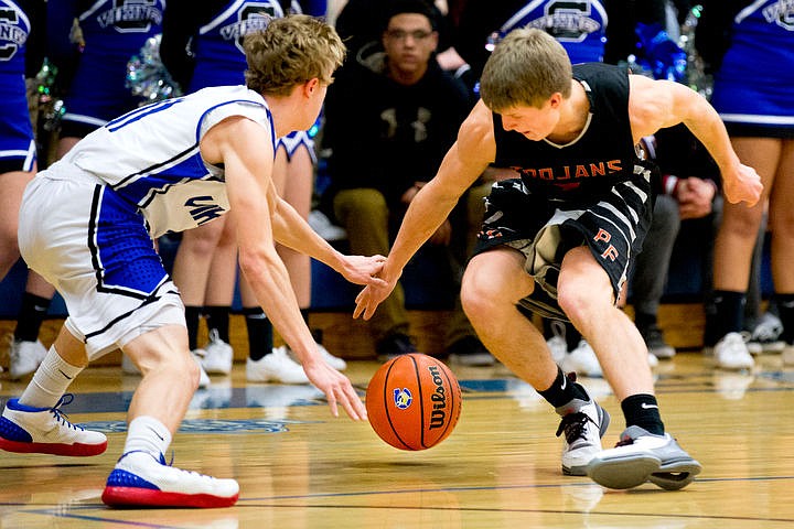 &lt;p&gt;Coeur d'Alene's Jakob Lynn, left, and Post Falls' Wyatt Millsap fight for a loose ball at the 5A Region 1 second-place game on Thursday, Feb. 25, 2016 at Coeur d'Alene High School. Post Falls defeated Coeur d'Alene 77-70.&lt;/p&gt;