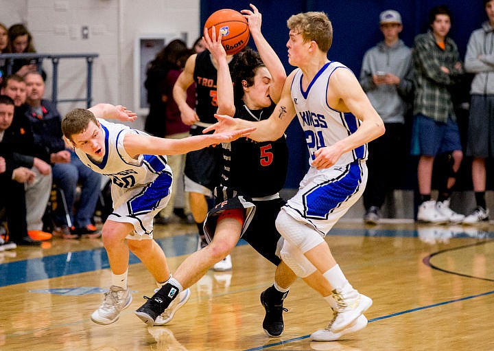 &lt;p&gt;Post Falls' Max McCullough is sandwiched between Coeur d'Alene's Sam Matheson, left, and Joey Naccarato at the 5A Region 1 second-place game on Thursday, Feb. 25, 2016 at Coeur d'Alene High School. Post Falls defeated Coeur d'Alene 77-70.&lt;/p&gt;