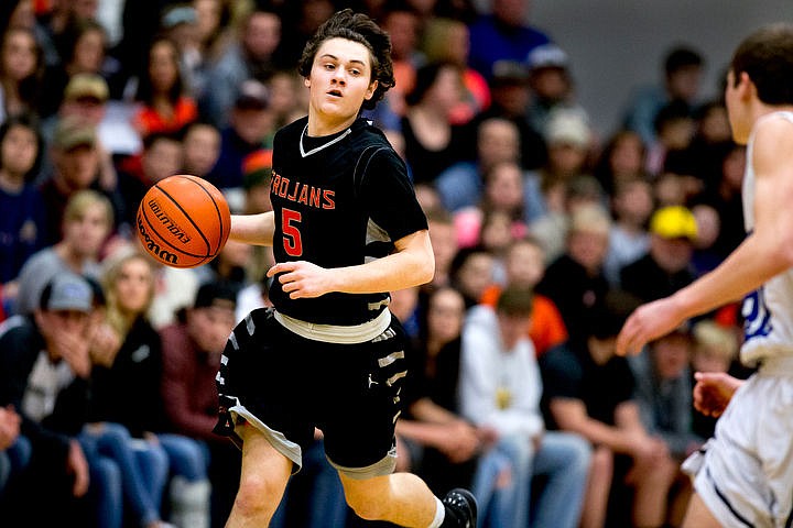 &lt;p&gt;Post Falls' Max McCullough looks for an open teammate as he dribbles up court at the 5A Region 1 second-place game on Thursday, Feb. 25, 2016 at Coeur d'Alene High School. Post Falls defeated Coeur d'Alene 77-70.&lt;/p&gt;