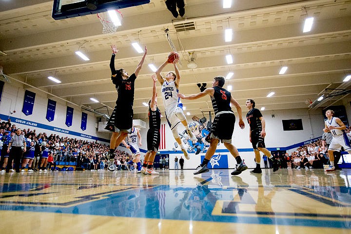 &lt;p&gt;Coeur d'Alene's Joey Naccarato (24) takes a jump shot as he's defended by Post Falls' Jacob Pfennigs (15), Zach Hillman and Wyatt Millsap (3) at the 5A Region 1 second-place game on Thursday, Feb. 25, 2016 at Coeur d'Alene High School. Post Falls defeated Coeur d'Alene 77-70.&lt;/p&gt;