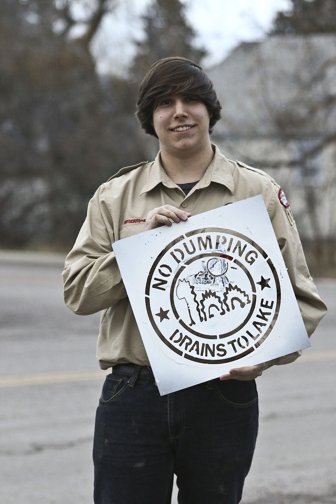 &lt;p&gt;Kenneth Maughan poses with the stencil he designed for the drains.&lt;/p&gt;