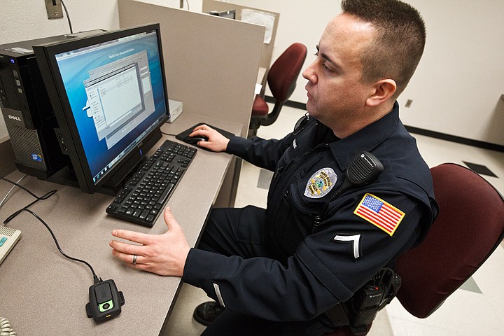 &lt;p&gt;Peter McManus, a patrol officer with the Post Falls Police Department, demonstrates the process of downloading video files from an on-person camera the are used by some officers in the department.&lt;/p&gt;