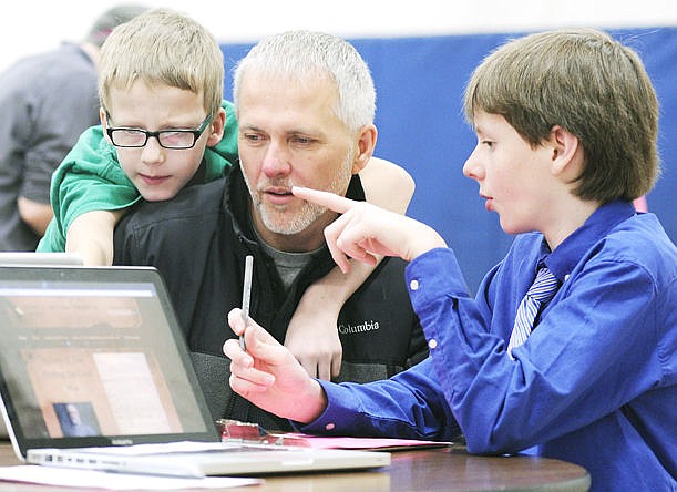 &lt;p&gt;Ben Johnson, right, explains the website he created on the Sicilian Wars to his dad, Gary, and brother Jack during the National History Day Fair at Bigfork Middle School on Tuesday. Ben said it was interesting to learn how something that happened around 500 B.C. has so much impact on what is happening today. (Aaric Bryan/Daily Inter Lake)&lt;/p&gt;