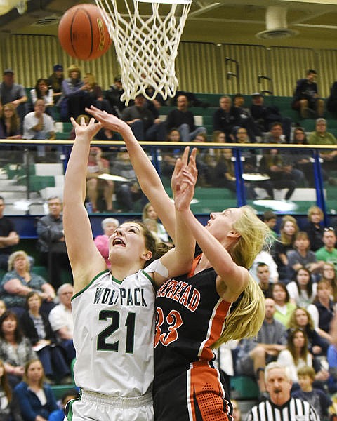 <p>Glacier's Nikki Krueger scores as Flathead's Tiana Johnson defends her during the second quarter at Glacier on Friday. (Aaric Bryan/Daily Inter Lake)</p>
