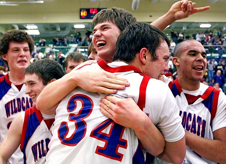 Columbia Falls' Mitchell Wassam (34) hugs teammate Tim Spencer as the team celebrates it's 60-46 win over the Polson Pirates to take the Northwestern Class A Divisional Championship Saturday evening at Glacier High School.
