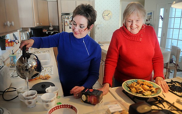 Leslie Collins, left, and Joan Binnie, making tea in Binnie's home on February 8. The two neighbors recently returned from Ferne, Alberta where they officially sent off the guitar and papers to the Canadian War Museum in Ottawa.