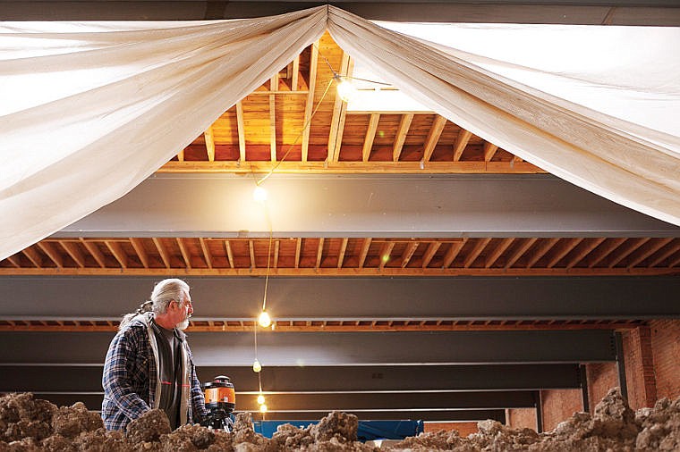 &lt;p&gt;Jim Beland adjusts a laser level Thursday afternoon at Kalispell Brewing Company. In the process of remodeling the building new structural steel beams were put in, and the ceiling had to be sandblasted to remove paint and drywall.&lt;/p&gt;