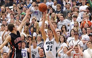 <p>The Wolfpack's Cody Norberg knocks down a 3-pointer over the Brave's Bridger Johnson in front of the Glacier student section to give the Wolfpack to give 41-32 in the final seconds of the third quarter. (Aaric Bryan/Daily Inter Lake)</p>