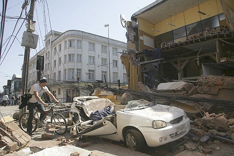 &lt;p&gt;A man rides his bicycle along a destroyed building in Concepcion, Chile, Saturday Feb. 27, 2010 after an 8.8-magnitude struck central Chile. The epicenter was 70 miles (115 kilometers) from Concepcion, Chile's second-largest city.(AP Photo)&lt;/p&gt;