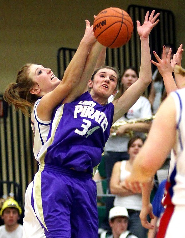 Columbia Falls' Kayla DeWit jumps up with Polson's Nicole Davey to keep her from intercepting a pass in the fourth quarter.