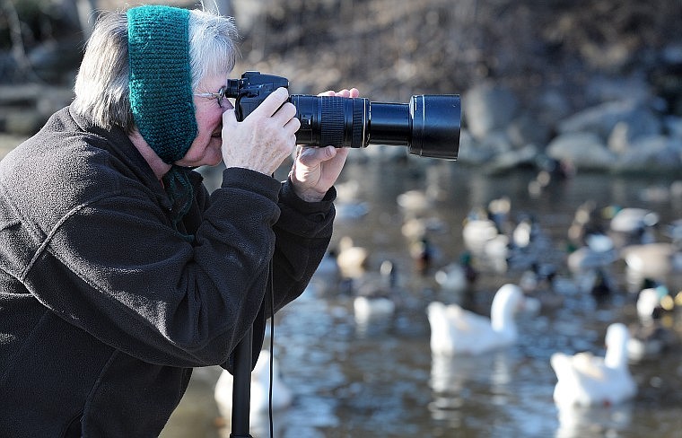 Devvi Morgan of Kalispell takes advantage of the sunlight to photograph the ducks and geese at Woodland Park on Monday. Morgan got her digital camera in 2005. She has been taking a photo a day ever since and e-mailing it to her family and friends as a way of keeping in touch.