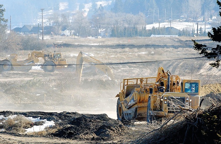 Ames Construction crews work Tuesday near Appleway Drive on part of the southern section of the U.S. 93 Alternate Route that will connect with U.S. 2 West.