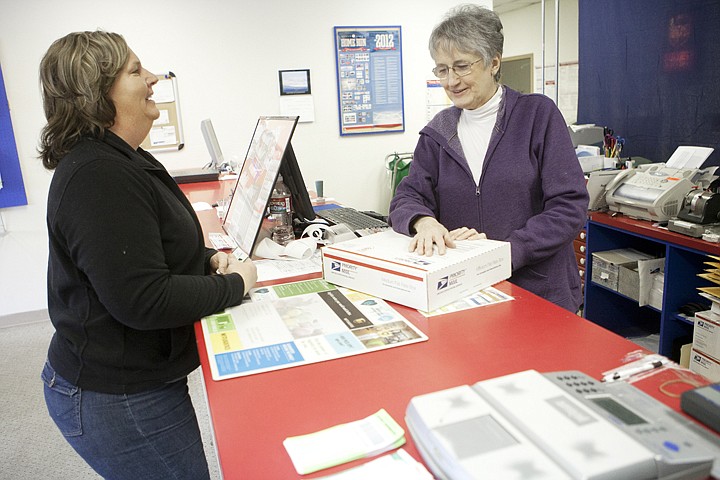 &lt;p&gt;Linda Graham, right, helps Heather Siderius at the Evergreen
Post Office Tuesday morning.&lt;/p&gt;