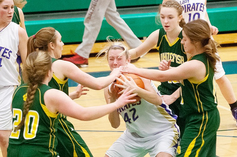 &lt;p&gt;Polson senior wing Monika Frame (42) protects the ball as Whitefish defenders collapse Thursday night during the Northwestern A Divisional tournament at Glacier High School. Feb. 27, 2014 in Kalispell, Montana. (Patrick Cote/Daily Inter Lake)&lt;/p&gt;