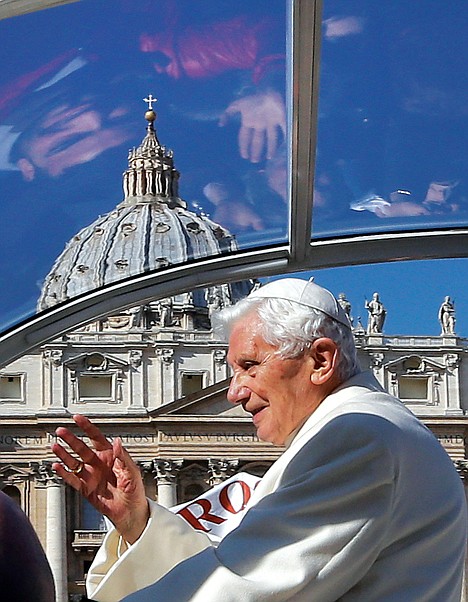 <p>Faithful are reflected in the roof of Pope Benedict XVI's pope-mobile as he arrives to celebrate his last general audience in St. Peter's Square, at the Vatican, Wednesday.</p>