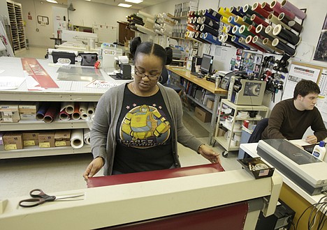 &lt;p&gt;Ceritas Reeves lines up a roll of vinyl to be printed and die cut with lettering Jan. 13 at Glavin Industries in Solon, Ohio.&lt;/p&gt;