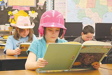 &lt;p&gt;Emma Lloyd, wearing her softball helmet to celebrate I Love to Read Month, reads the &quot;World of Rabbits&quot; at K. William Harvey Elementary School in Ronan last Friday.&lt;/p&gt;