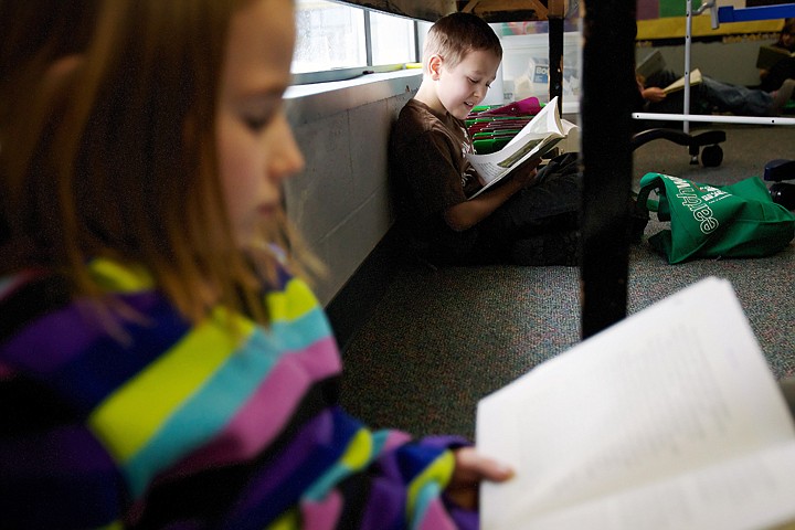 &lt;p&gt;Joseph Gabriel, right, sits under a table in his third-grade classroom Monday as he enjoys a book while his classmate Lauren Hahner reads her book.&lt;/p&gt;