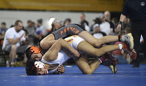 &lt;p&gt;Columbia's Flavio Rosales, bottom, tries to escape from Post Falls' Alius De La Rosa of Post Falls, in the 5A 138-pound championship during the state wrestling tournament Saturday at Holt Arena in Pocatello. De La Rosa, a junior, won his third state title.&#160;&lt;/p&gt;