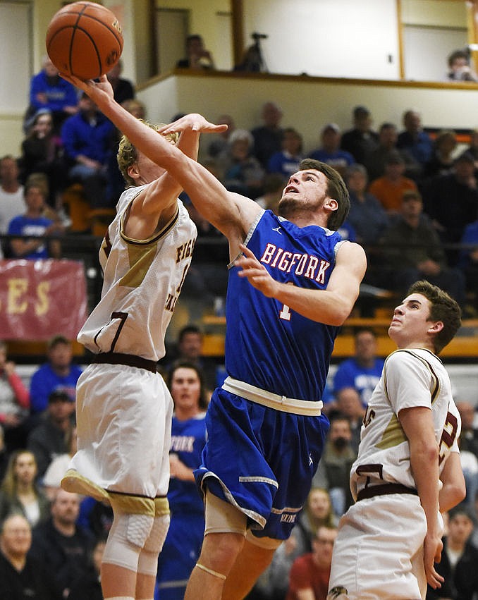 &lt;p&gt;Bigfork's Adam Jordt flies past Florence's Levi Clagett, left, and Daniel Parson for a basket in the Vikings' 65-54 championship victory at the Western B Divisionals at Flathead on Saturday. (Aaric Bryan/Daily Inter Lake)&lt;/p&gt;