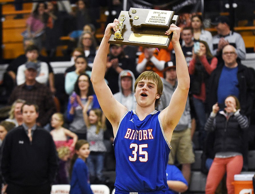 &lt;p&gt;Garrett Beville holds up the Western B Divisional Championship trophy after the Vikings defeated the Florence Falcons 65-54 at Flathead on Saturday. (Aaric Bryan/Daily Inter Lake)&lt;/p&gt;