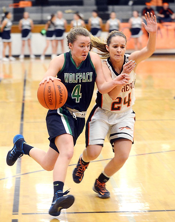 &lt;p&gt;Glacier sophomore Hailee Bennett drives the ball down the court under pressure from Flathead freshman Kelsey Noland-Gillespie during the crosstown game on Friday at Flathead. Glacier won the game 60-52. (Brenda Ahearn/Daily Inter Lake)&lt;/p&gt;