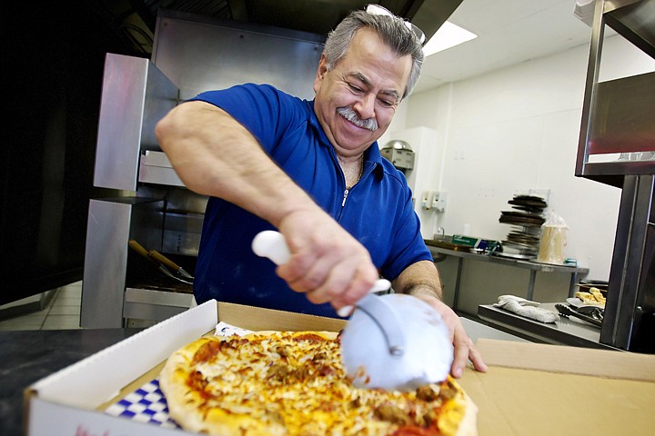 &lt;p&gt;Peter Karatzas, owner of Greek Street Pizza, slices a pizza at his Coeur d'Alene restaurant Monday. Karatzas has owned 20 restaurants over his 45-year career as a chef specializing in Greek, Northern Italian and French cuisines.&lt;/p&gt;