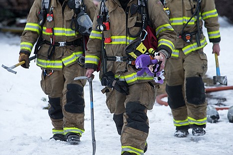 &lt;p&gt;A firefighter carries children&#146;s toys from an apartment complex in the 4200 block of North Crown Avenue which caught fire early Friday morning. Six children were taken to Kootenai Health for smoke inhalation treatment.&lt;/p&gt;