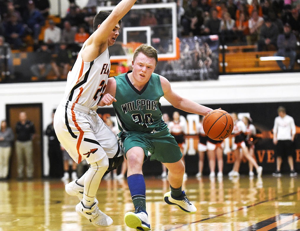 &lt;p&gt;Glacier's Jake Willich is fouled by Flathead's C.J. Dugan during the Wolfpack's 52-37 in the state play-in game at Flathead on Tuesday. (Aaric Bryan/Daily Inter Lake)&lt;/p&gt;