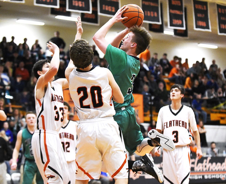 &lt;p&gt;Glacier's Blayne Bailey shoots over Flathead's Bridger Johnson during the Wolfpack's 52-37 win in the state play-in game at Flathead on Tuesday. (Aaric Bryan/Daily Inter Lake)&lt;/p&gt;