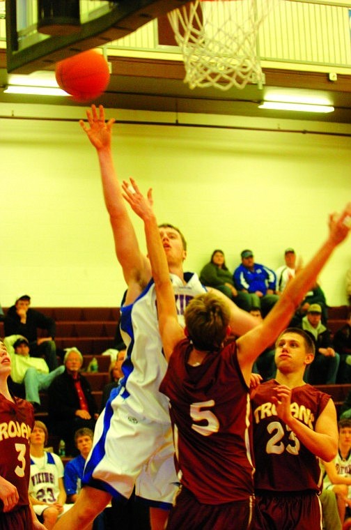 Bigfork senior Christian Ker puts up a shot over Troy's Ryan Rayson (5) during the final minutes of the Vikings' Monday night challenge game against Troy in the Western B Divisional Tournament in Pablo. Bigfork won the contest 57-39 and retained its berth at the Class B State Tournament, which will be played March 10-12 in Great Falls.