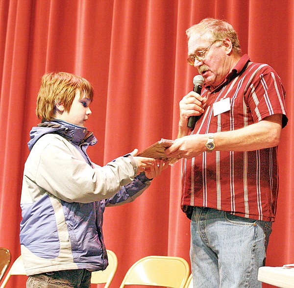 Kaleb Boyd of Libby Middle School receives the runner-up award from Ron Higgins, Lincoln County superintendent of schools, last week in Eureka.