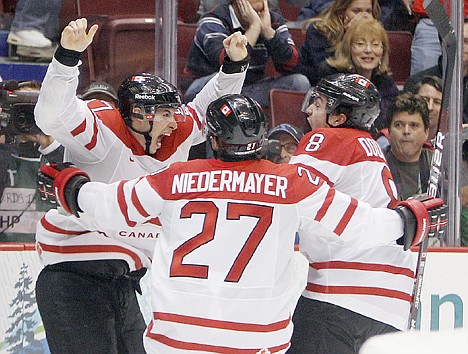 &lt;p&gt;Canada&#146;s Sidney Crosby (87) is congratulated by Drew Doughty (8) and Scott Niedermayer (27) after Crosby scored the game-winning goal in overtime of the men&#146;s gold medal hockey game against the USA on Sunday in Vancouver, British Columbia.&lt;/p&gt;